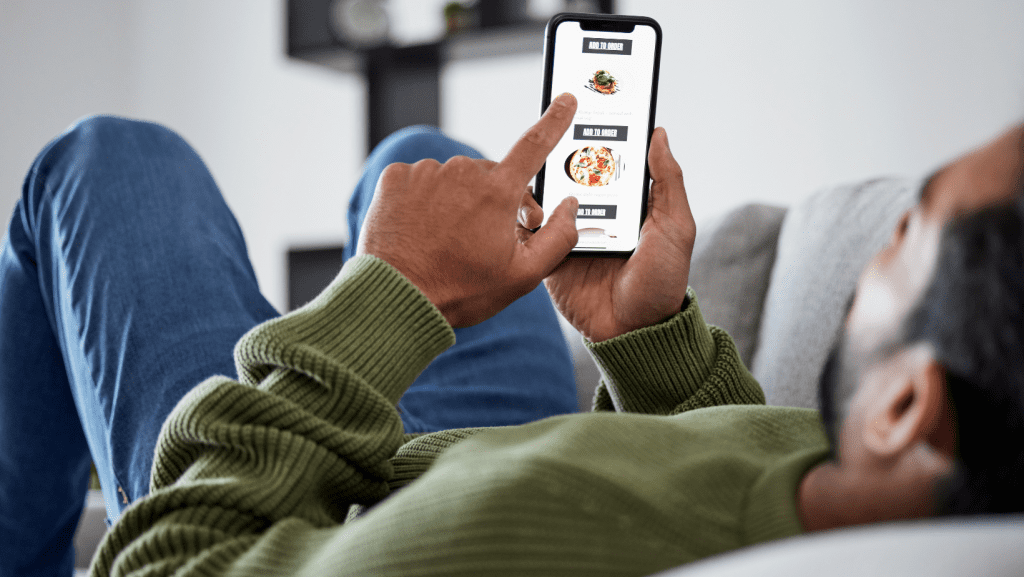 A person looking at the photos of a restaurant uploaded to Google on their mobile phone.