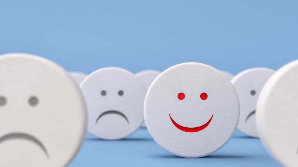 Icons of sad faces and only one smiling face