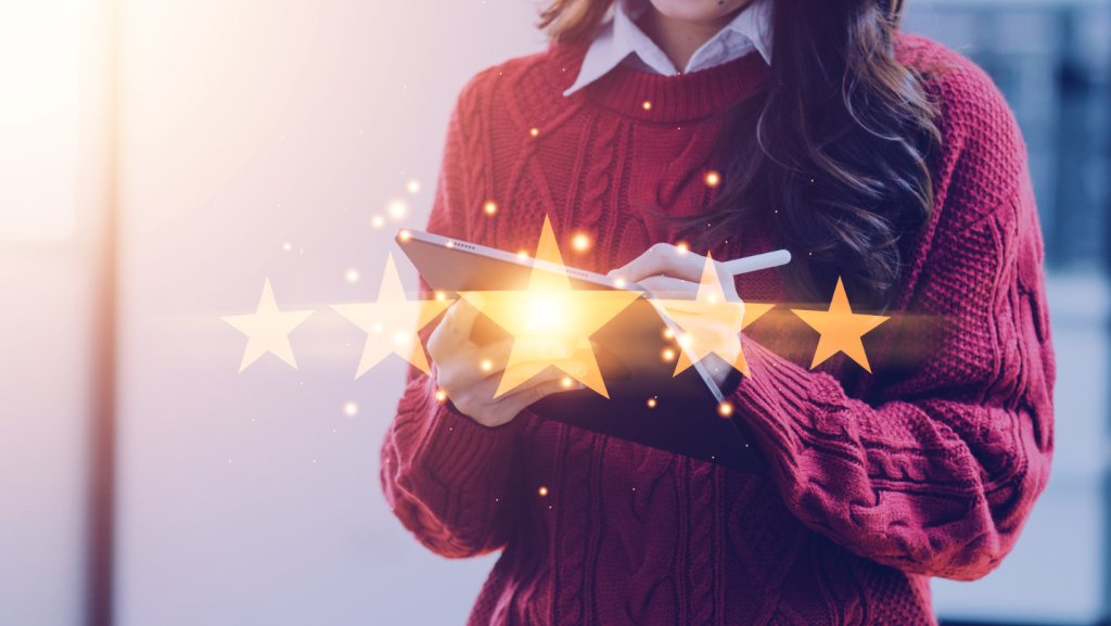 Woman placing 5 stars on a review with her mobile phone