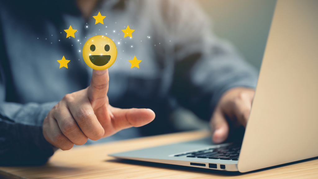 Person leaving a 5-star review with their computer